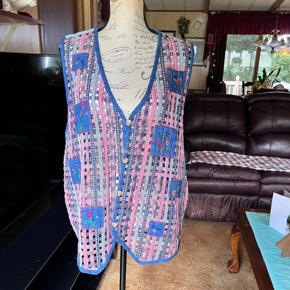 Victoria Jones Woman vintage woven denim vest with embroidered floral patches.